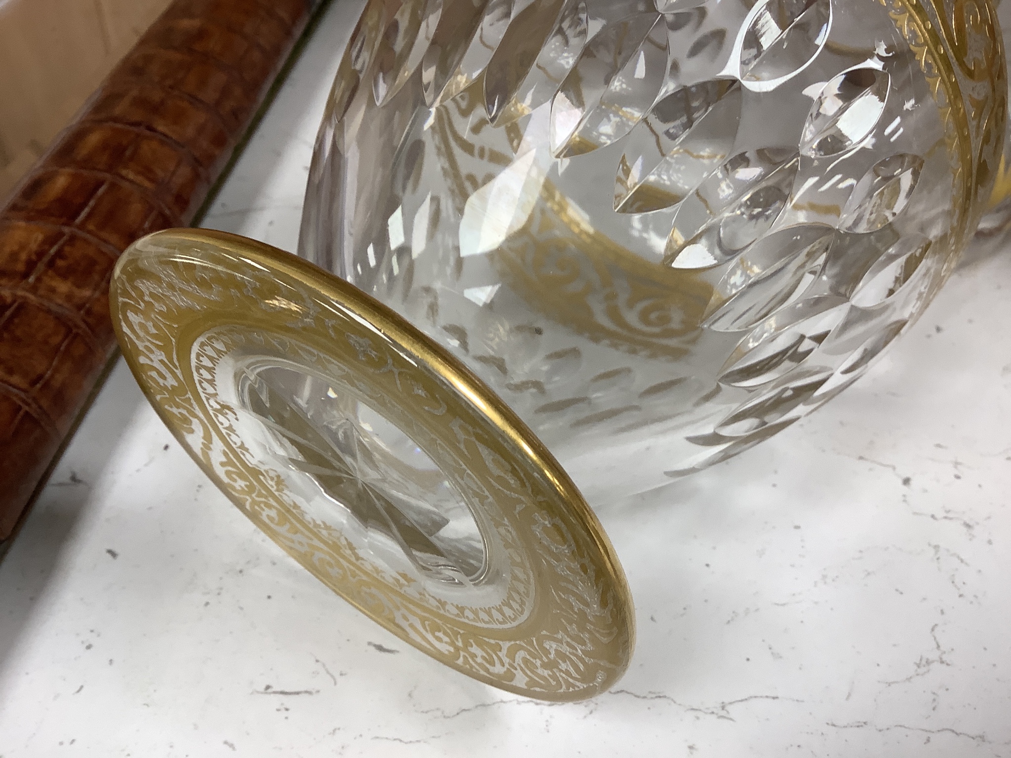 A Baccarat gilt and cut glass jug and a strawberry cut glass decanter and stopper, tallest 38 cm